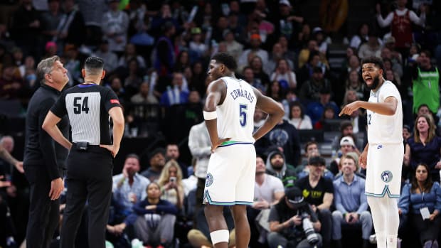 Feb 23, 2024; Minneapolis, Minnesota, USA; Minnesota Timberwolves center Karl-Anthony Towns (32) argues after he was charged with a foul against the Milwaukee Bucks during the second half at Target Center. Mandatory Credit: Matt Krohn-USA TODAY Sports